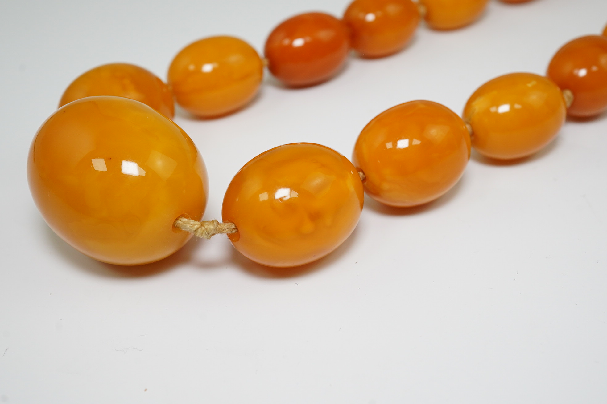 A single strand graduated oval amber bead necklace